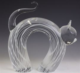 Murano art glass cat by Licio Zanetti. Crafted of fine Italian glass. Depicts an ally cat with arched back. Clear crystal with white striping and curled tail. Signed/etched on bottom 'Zanetti'. Measures 8" x 8 1/2". Very good condition with mild surface scratching to base. In house USA continental shipping $55 plus insurance.