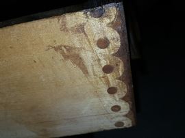 The Knapp joint was developed during the late Victoria Era in post-Civil War United States.  This type of joint is also known as pin-and-cove or half moon.  This type of joint is very strong and can be constructed with the use of machinery which means production on a mass scale was possible in a factory setting.

The Knapp joint, patented by Charles Knapp of Waterloo, WI in 1867, was a huge advance for the furniture industry because it could be made quickly by machines called routers, which could create circular cuts in wood.  This meant that a the furniture factory could produce quality construction at a faster rate than shops that still relied on hand tools.

This technique was primarily used from around 1870 until 1900.