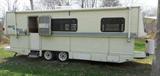 1995 Hi-Lo 26' camper. Electric lift. Very good condition. Queen-size bed and large twin bed. Air conditioning. TV antenna. 3-way refrigerator. Solid square metal tubing in walls. 5,000 lbs. Electric tongue jack. LP stove and oven. Wired for cable.