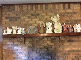Shelf full of angels over fireplace