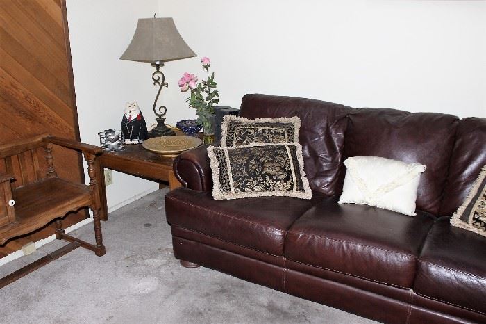 leather couches, end table, iron lamp