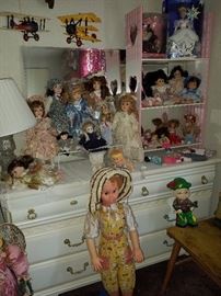 White dresser, mirror, doll collection, and more