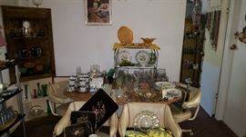 Kitchen table & chairs, lots of dishes/glass.