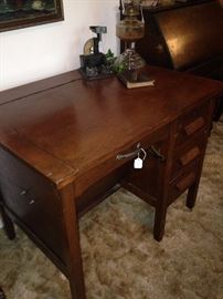 The antique desk converts to a desk with a smooth top.