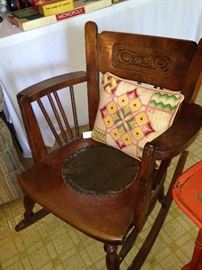 Antique rocker and needlework pillow