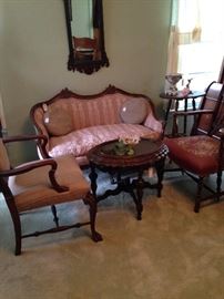 Antique settee, chairs, oval coffee table, and mirror