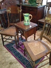 Two (of four) antique chairs put out a window during a house fire----- the only furniture saved; small antique side table