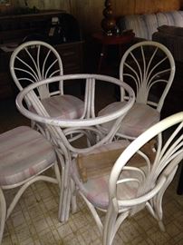 Rattan table with 4 chairs (glass top is missing)