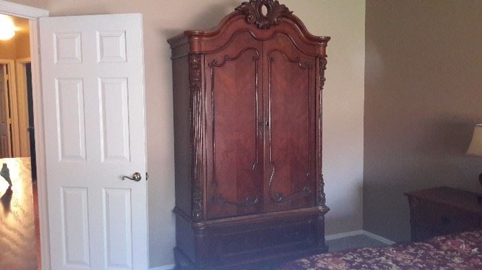 Antique solid wood armoire. Separates into two pieces for moving.