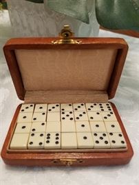 Complete box of miniature dominoes in leather case. $35