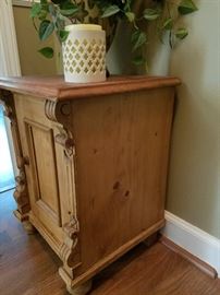 Side view of Antique Carved Accent Table with Door. $150.
