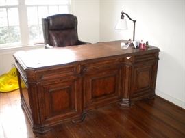 Executive desk, executive leather nail head trim office chair, and executive lateral file cabinet