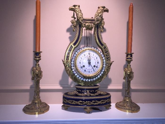The clock has sold  the candlesticks are available