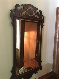 Decorative antique hall mirror with gold gilded accents.