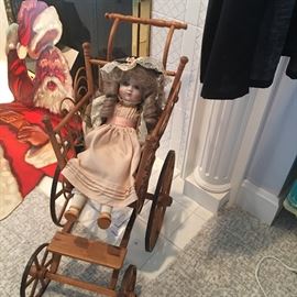 Antique child's doll stroller and vintage doll.