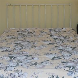 French Style Iron Headboard: A French style iron headboard. This sleigh style headboard and framing feature a slightly curved back with scrolls to the side of the framing. The piece is fashioned with a white painted on finish. This listing is for the bed headboard and frame only, the mattresses and bedding in the photos are not included.