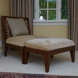 Modern Slant Back Chair With Ottoman: A Modern slant back chair with ottoman. This accent chair features a wood frame square back with woven detail on a square seat with upholstered cushion rising on tapered legs. The rectangular ottoman features an upholstered cushion rising on tapered legs. These pieces are upholstered in a beige fabric. There are no visible maker’s marks or labels on these pieces.