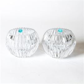 Pair of Tiffany & Co. Crystal Votives: A pair of Tiffany & Co. votives. Each features a serrated edge and a fluted body. They are etched “Tiffany & Co” on the underside.