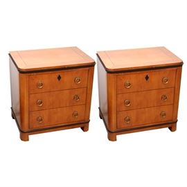 Pair of National Mt. Airy Biedermeier Bedside Tables: A pair of National Mt. Airy Biedermeier bedside tables. Each features a natural wood construction with dovetail joinery. They have three drawers each with brass ring pulls. Marked to the interior of the top drawer.