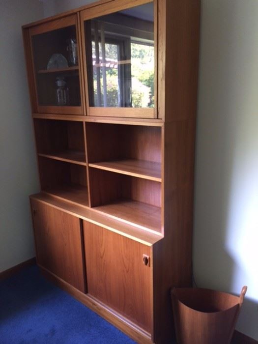 Two identical Poul Hundevad 40/50 series teak cabinets. Purchased from Scandinavian Design in the 1980's. Top: 47" X 24" X 11.5", glass panels, 1 adjustable shelf, lighted                                               Middle: Bookcase, 47" X 24" X 11.5"                         
Bottom: 47" X 28" X 16" Sliding doors                      
This piece is actually three individual units, stacked onto each other. Total height when stacked: 75"    
The base would make a fantastic side cabinet for a bedroom, living room, or as cabinets for a dining room. These pieces are in excellent condition!
