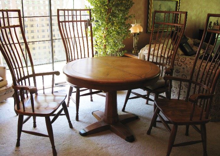 Beautiful solid oak birdcage windsor back dining table with one leaf and pads. Purchase in New Orleans years ago.  