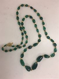 27" strand of natural Emerald nugget beads with 22k gold beads and toggle closure.