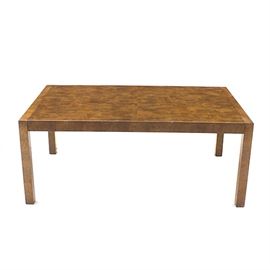 Burled Walnut Dining Table: A modernist dining table in burled walnut veneer. It has a rectangular tabletop that can be expanded using two included insert leaves, and stands on square legs. Unmarked.
