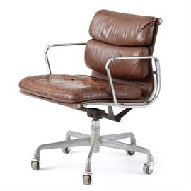 Vintage Eames for Herman Miller "Aluminum Group" Desk Chair: A mid-century vintage desk chair, designed by Charles and Ray Eames for Herman Miller, for the “Aluminum Group” series. It is upholstered in brown leather with a steel frame, and has a swivel seat and rolling base.