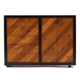 Mid-Century Modern Oak Sideboard: A Mid-Century Modern vintage sideboard, in oak veneer. It has draw leaf extensions to either side. The body of the piece has five drawers to the left, with metal handles and dovetail joints, and a removable silverware board to the top drawer. To the right is a cabinet space with a single adjustable / removable shelf. The piece rolls on casters to the base. Unmarked.