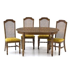 Mid-Century Modern Dining Set: A vintage Mid-Century Modern dining set, including table and four chairs. The table has an oval top in faux wood laminate veneer, on a birch base, with square legs. It can be expanded with the included leaf insert panel. The chairs have caned backs, and golden yellow velvet seats with parallel channels, and stand on square legs matching those of the table, with spreaders. Unmarked.
