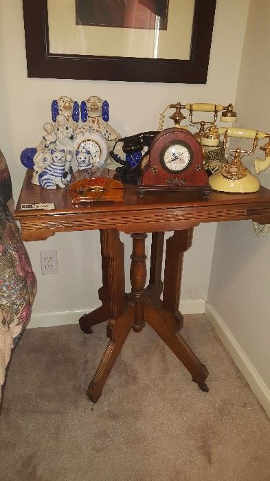 Nice side table with clocks, princess phones and Staffordshire terriers