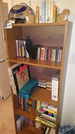 Bookshelf with cassettes and cd's and a small stereo