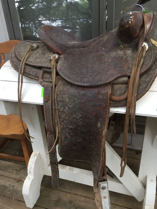 Hand tooled leather saddle and saddle rack, 
"Back in the saddle again" 