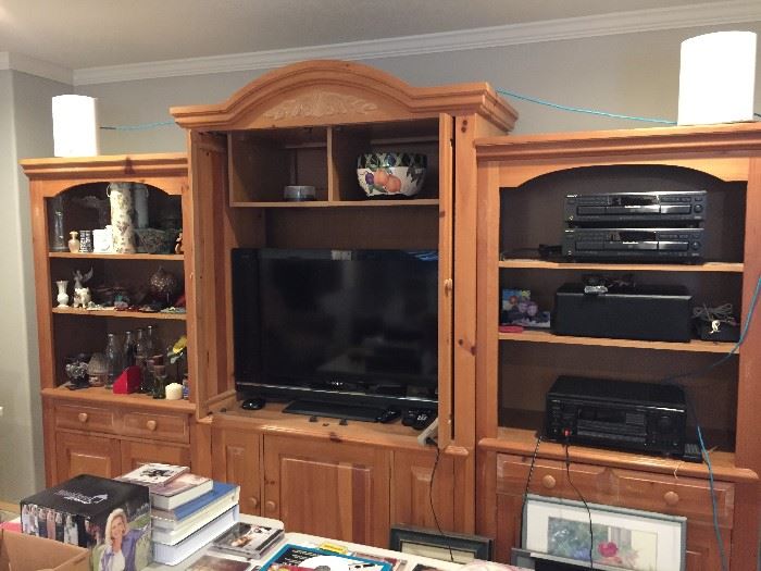 Entertainment center with central TV unit (holds up to a 40" TV) and two side bookcases with storage).