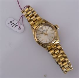 Rolex 14k Gold Ladies Wrist Watch 	
retailed by Tiffany & Co.
1" face, with replaced stainless
bracelet, 7 1/2" long