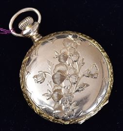 Waltham 14k Gold Pocket Watch 	
with floral engraved hunter's case
1 1/8" diameter, 21.8 dwt gross
early 20th century