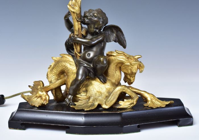 Pair of French Parcel Gilt Bronze Candelabra
supported by a cherub riding a seahorse
now adapted to lamps
38" high
late 19th century