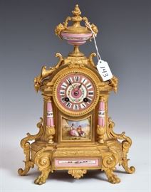 French Bronze Mantel Clock 	
with porcelain face and mounts
14" high
late 19th century