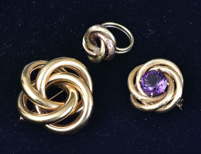 Two 14k Gold Brooches
one set with an amethyst, 
the larger 1 1/2" long together with
a two tone 14k gold ring
21.4 dwt gross