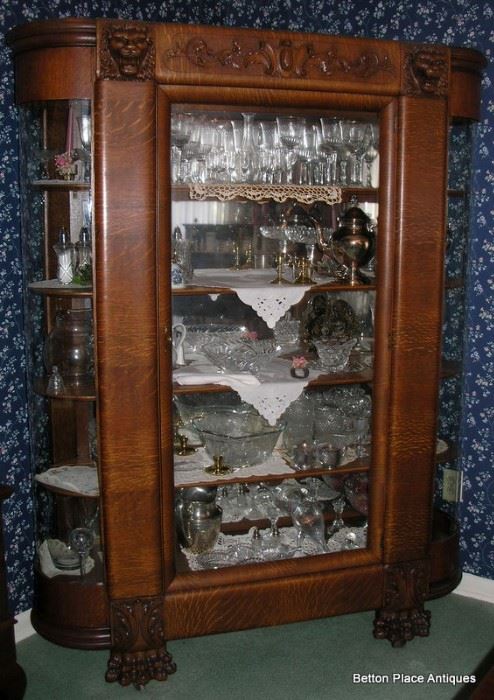 Late 19th Century Quarter Sawn Oak Display Cabinet, serpentine sides, Griffin Heads at the top, Lion Claw feet. Magnificent piece, standing 73 inches, width 57 inches and depth 16 inches.