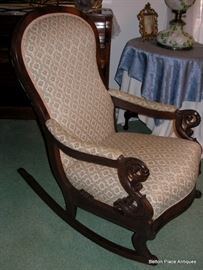 Side view of Ladies Mahogany Rocker, with turned arms.