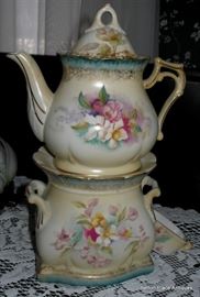 Tea for One, Teapot on the top, spoon in the side, Base for hot water to stay warm.