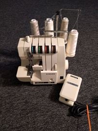 Singer Serger Sewing Machine with case and foot pedal.