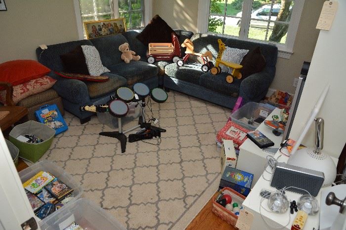 sectional sofa, drum set, guitars, toys
