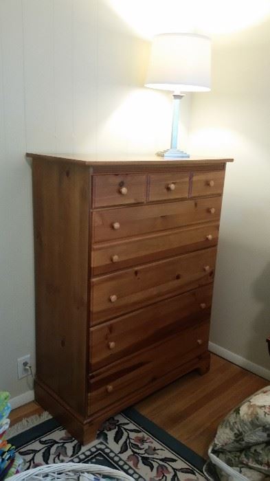 Large chest of drawers, silvertone lamp, blue room-sized rug