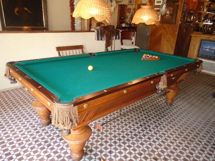 1899 Brunswick Narragansett.or Syracuse. 3 slate pool table 9 feet by 4 1/2 half feet. 
This table is in amazing condition. The only work done was the cushions and felt were replaced about 30 years ago. There are no marks scratches burns to the wood. With original patent number plates, and Brunswick tin label, dated 1899. plate may not be original but switched. still researching Some wear. . Constructed of quarter-sawn oak, the heavy body and sturdy legs assure positive rigidity . Three-piece slate playing surface. Nine-foot size shown.