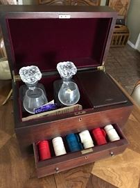 Inside of bar game set with crystal glasses and decanters. Poker chips and cards
