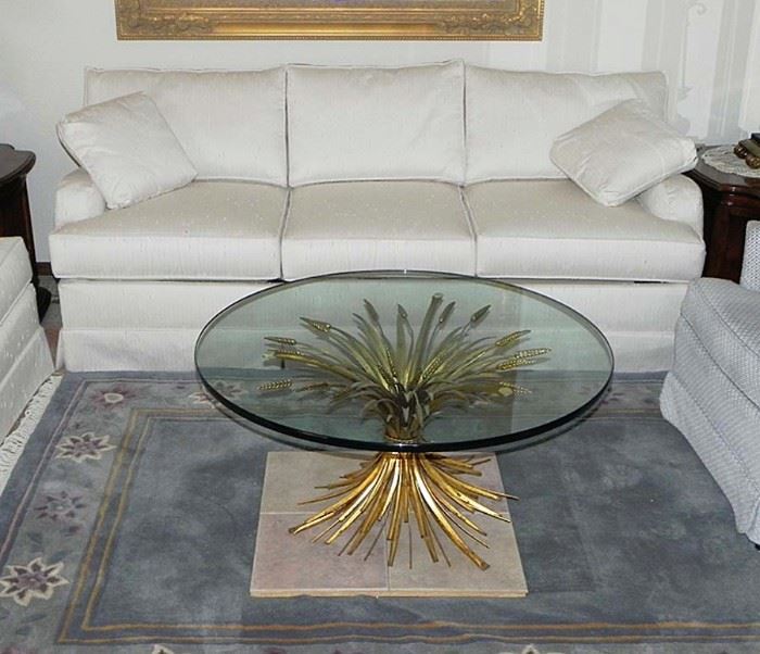 Glass top coffee table with gilded accents