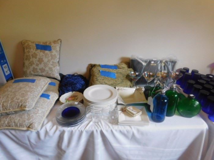 Decorative pillows and colored glass bottles