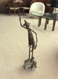 Copper sculpture of fisherman on marble